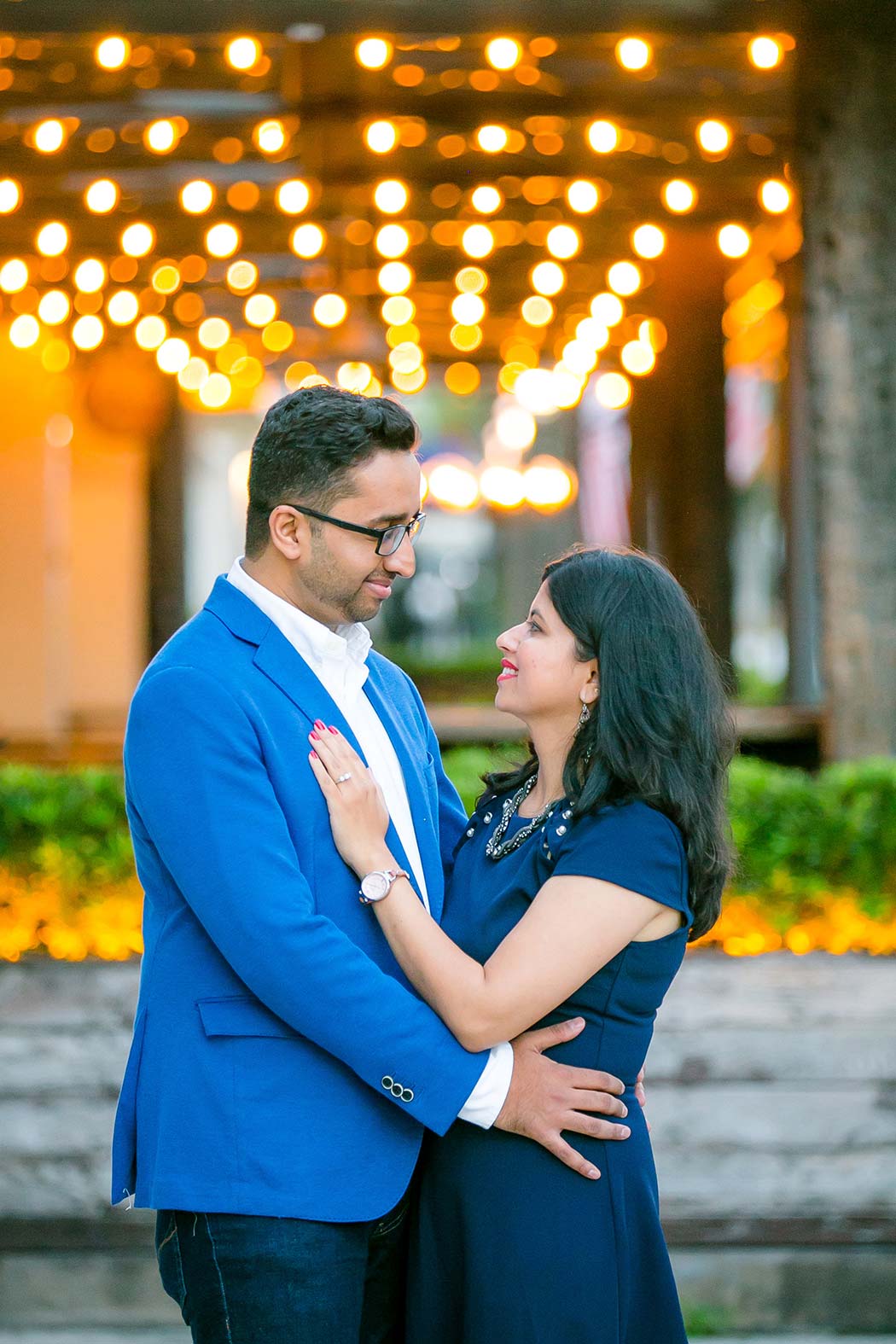 indian couple pose for family photography on las olas boulevard with lights