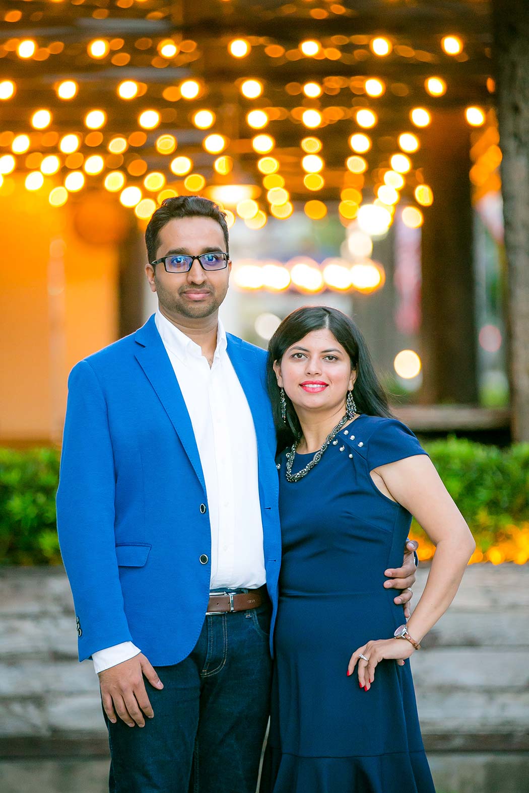 indian couple pose for family photos with lights in background on las olas boulevard | family photographer fort lauderdale
