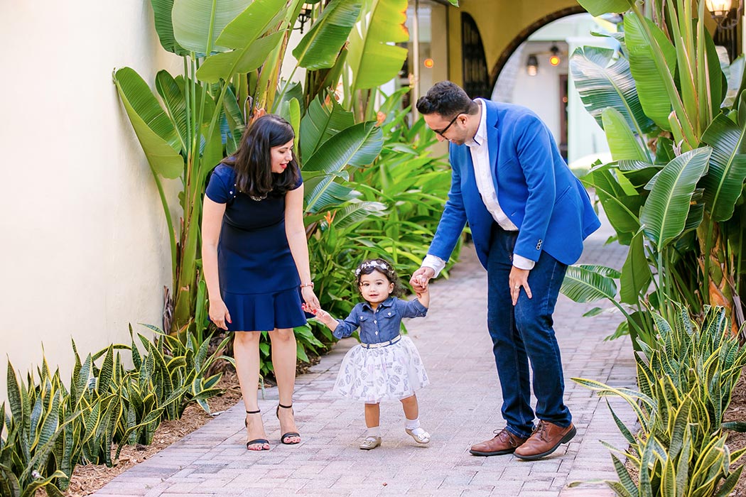 adorable baby walks towards camera during family photography session in south florida