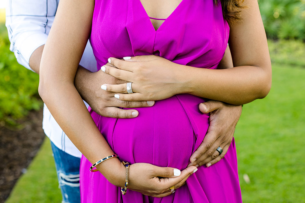 unique maternity posing with hands round belly