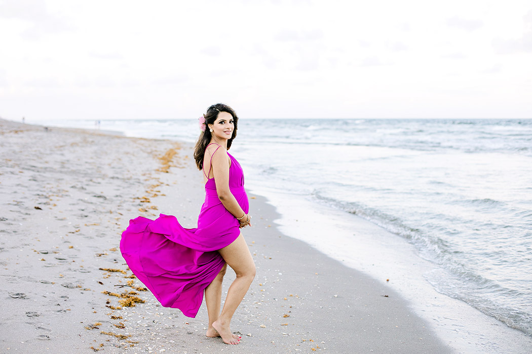 pink maternity dress during beach maternity photography in south florida